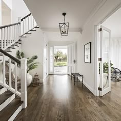 an entry way with wood floors and white walls