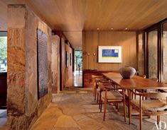 a dining room with wooden tables and chairs