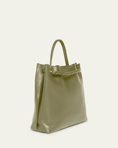 Bottega Veneta "Andiamo" tote bag in silky calf leather     Top handle     Sliding shoulder strap with knot hardware accent     Can be worn as a top handle or shoulder bag     Open top with magnetic closure     Interior, one zip pocket and two slip pockets     Lining: Suede    Feet protect bottom of bag     Approx. 9.8"H x 12.5"W x 4.3"D    Made in Italy Chic Leather Bucket Bag With Rolled Handles, Chic Leather Hobo Bag With Rolled Handles, Evening Satchel With Rolled Top Handles, Leather Satchel With Rolled Handles For Evening, Evening Satchel With Rolled Handles, Elegant Shoulder Bag With Rolled Handles For Daily Use, Shoulder Bag With Rolled Handles For Everyday, Evening Bag With Rolled Round Handles, Formal Top Handle Shoulder Bag With Rolled Handles