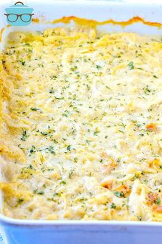 a casserole dish with cheese and vegetables in it on a blue table cloth