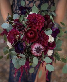 a woman holding a bouquet of flowers in her hands