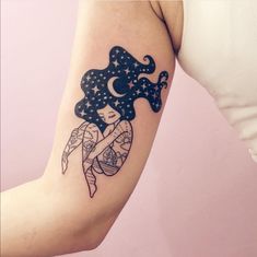 a woman's arm with a tattoo on it that has an image of a fairy holding a star