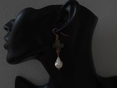 Stylish Baroque Pearls are given an oriental twist with the addition of these Chinese knots that symbolize a long and happy life full of good fortune. The organic shape of the Baroque Pearls are set in contrast to the symmetrical knots carved out of Mother of Pearl. The ear hooks are laser cut for that extra sparkle and help your earrings stay on without fear of losing them. These elegant earrings are what you need to make a quiet, powerful statement. Gemstone: Mother of Pearl, Baroque Pearl Kno Handmade Rose Gold Elegant Bridal Earrings, Handmade Elegant Rose Gold Bridal Earrings, Handmade Elegant Baroque Earrings, Elegant Handmade Baroque Earrings, Baroque Single Earring Jewelry Gift, Baroque Pierced Earrings As Gift, Elegant Filigree Baroque Earrings, Handmade Rose Gold Earrings For Formal Occasions, Elegant Baroque Filigree Earrings