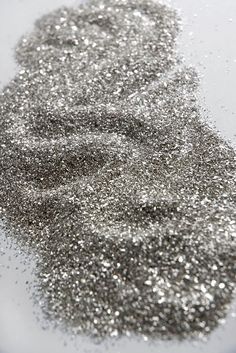 a pile of silver glitter sitting on top of a table