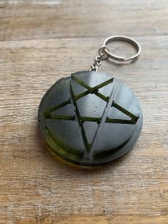 a stone keychain sitting on top of a wooden table