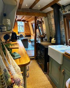 a kitchen area with sink, stove and counter top in it's own home