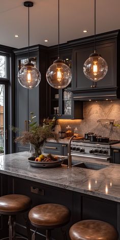 a kitchen with three lights hanging from the ceiling