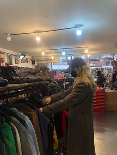 a woman wearing a face mask in a clothing store