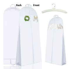 two white bags with green wreaths on them and hangers attached to each bag