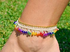 a woman's foot wearing a colorful bracelet