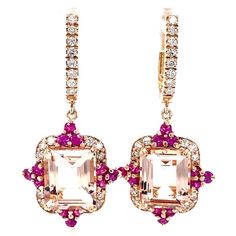 These earrings have Emerald Cut Morganites that weigh 8.65 carats, Round Cut Pink Sapphires that weigh 1.08 carats, and Round Cut Diamonds that weigh 0.67 carats. The total carat weight of the earrings is 10.40 carats. The earrings are crafted in 14 Karat Rose Gold and approximately weigh 9.4 grams. The length of the earrings is 1.5 inches. Luxury Yellow Gold Pink Sapphire Earrings, Morganite Earrings, Rose Gold Drop Earrings, Rose Gold Morganite, Morganite Diamond, Gold Drop Earrings, Rose Gold Earrings, Morganite, Pink Sapphire