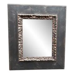 a mirror that is sitting on top of a wooden frame with an ornate design in the middle