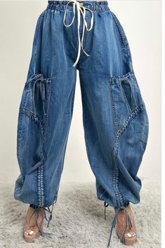 These Relaxed Cargo Denim Pants blend comfort with functionality, featuring a loose, relaxed fit that is perfect for a casual yet stylish look. Crafted from high-quality denim, these pants boast a unique design with multiple pockets and drawstring details at the waist and ankles, offering both practicality and a touch of edgy flair. The distressed stitching and oversized silhouette make these pants a standout piece, ideal for pairing with a variety of tops for a versatile outfit. Model wearing s Cargo Denim Pants, Denim Scraps, Diy Jacket, Balloon Pants, Classy Casual Outfits, Classy Casual, Versatile Outfits, Oversized Silhouette, Fashion Week Street Style