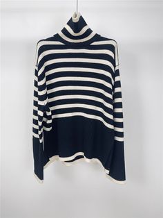 Features: This loose striped turtle neck sweater is the perfect combination of fashion and comfort. The elegant design and warm knit material make it a great option for casual wear. With its relaxed fit and stylish stripes, this sweater is a must-have for any fashion-forward woman. Stay warm and stylish this season with this high-quality pullover. White Striped Hem Sweater For Fall, Black Horizontal Stripe Sweater For Fall, Winter Knit Sweater With Striped Hem, Chic Fall Sweater With Striped Collar, Chic Sweater With Contrast Stripes For Winter, Oversized Winter Sweater With Contrast Stripes, Black Horizontal Stripe Winter Sweater, White Striped Hem Sweater For Winter, Trendy Horizontal Stripe Sweater For Winter