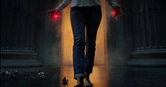 a person walking in the dark with red lights on their feet and hands behind them