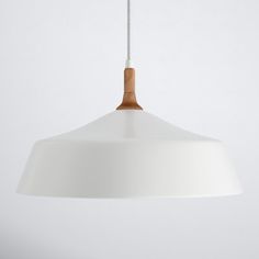 a white pendant light hanging from a ceiling fixture with a wooden handle on the end