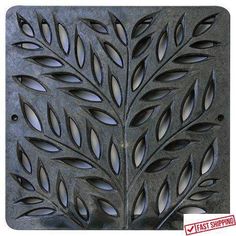 a decorative metal plate with leaves on it