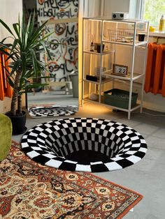 two rugs with black and white designs are on the floor next to each other