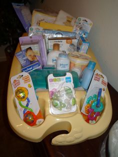 a baby's diaper tray with various items in it on top of a table