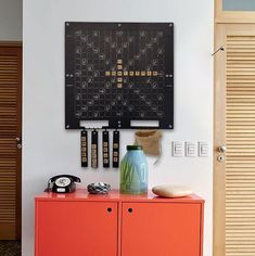 an orange cabinet is in front of a black and white board