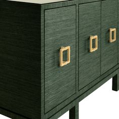 a green cabinet with brass handles and drawers