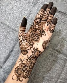 the hand is decorated with henna and flowers