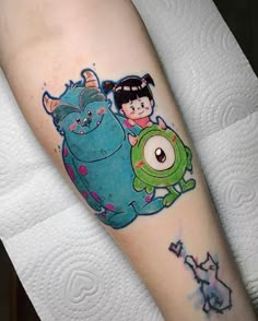 an arm tattoo with cartoon characters on it