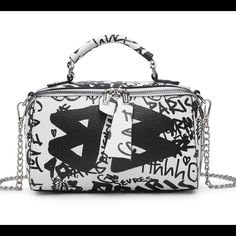 Zip Closure Interior Zip Pocket Detachable Crossbody Strap Gold Or Silver Tone Hardware Dimensions: 8.5"L X 3"W X 5"H Speed Bag, Black Vegan, Online Boutique, Effortless Style, Duffle Bag, Zip Pockets, Graffiti, White And Black, Silver Tone