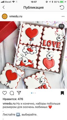 some cookies are in a box with hearts on them and the words love is spelled