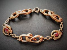 "10k Rose Gold Bracelet,, Gold Ruby Bracelet , Victorian Bracelet, Antique Gold Bracelet, Art Nouveau Bracelet, Love Knot Bracelet, Infinity Bracelet, Yellow Gold Bracelet, Antique Ruby Bracelet, Ruby Bracelet Antique Esemco Art Nouveau Art Deco 10k Rose Gold Love Knot Ruby Bracelet Stunning Esemco Art Nouveau era bracelet. Beautiful infinity or love knot style links crafted in 10k rose gold. Two bezel set 4mm faceted simulated rubies flank the center charm. Weighs about 7.6 grams. Hallmarked 10 Victorian Bracelet With 17 Jewels For Gift, Hallmarked Rose Gold Bracelets, Antique Rose Gold Bracelets For Formal Occasions, Victorian Rose Gold Bracelets As Gift, Victorian Rose Gold Bracelets Gift, Vintage Rose Gold Bracelets For Gift, Vintage Rose Gold Bracelet For Gift, Vintage Rose Gold Bracelet Gift, Victorian Bracelet Antique