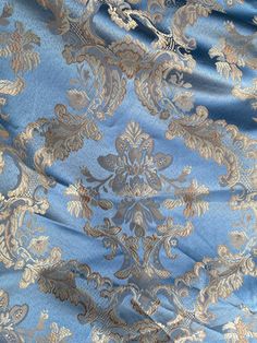 a blue and gold brocaded fabric