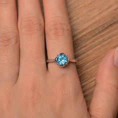 It is a real Swiss blue topaz ring, round cut, measures 7mm*7mm, weight about 1.68 cts. The basic metal is sterling silver and plated with rhodium. To change the metal to a solid gold (white/rose) or platinum is also available, please ask for a quotation if you want. You can also go to my shop Home for more elegant rings: https://www.etsy.com/shop/godjewelry?ref=hdr_shop_menu Swiss blue topaz is birthstone of November More Swiss blue topaz rings: https://www.etsy.com/shop/godjewelry?ref=seller-p Blue Solitaire Topaz Ring With Round Stone, Blue Solitaire Topaz Ring Round Cut, Blue Topaz Solitaire Ring Round Cut, Blue Solitaire Birthstone Ring With Round Stone, Blue Solitaire Birthstone Ring, Classic Blue Topaz Birthstone Ring, Round Cut, Classic Birthstone Ring With Round Cut Blue Topaz, Classic Round Cut Blue Topaz Birthstone Ring, Classic Blue Topaz Birthstone Ring