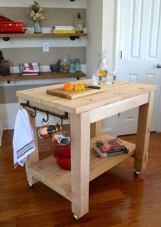 a kitchen island made out of wood with pots and pans on the shelf next to it