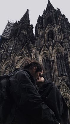 a man standing in front of a large cathedral