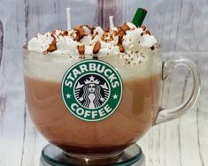 there is a cup of starbucks coffee with whipped cream and chocolate toppings in it