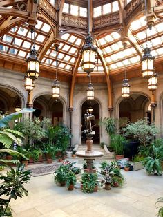 the inside of a building with lots of plants