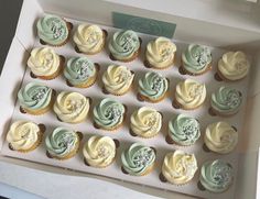 a box filled with cupcakes covered in frosting