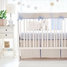 a baby crib in a white room with blue trimmings and stars on the wall