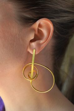 Musical note inspired abstract contemporary gold statement earrings. Perfect gift for musician friend. Material: Brass (100% skin friendly) Coating: 18 Kt Gold (thick layer)  Making: 100% Handmade Electrophoretic Coating for Scratch Resistance & Long Life Nickel, Lead & Cadmium Free (International Lab Certificate) Modern Yellow Gold Wrap Earrings, Modern Brass Wrap Earrings, Modern Brass Wrap Earrings For Gift, Modern Brass Wrap Earrings As Gift, Modern Gold Single Wrap Earring, Modern Gold Wrap Earrings For Pierced Ears, Modern Gold Earrings With Unique Design, Edgy Earrings, Abstract Jewelry