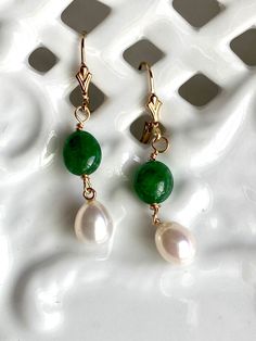 These Akoyas pearls are from the estate of a jeweler in Connecticut that I picked up last year on my New England buy.  These are from the 1980's according to the label on the sleeve. Gorgeous creamy white iridescent nacre. The 10mm Brazilian emeralds are new. 14k gold filled filled beads, on 14k gold filled ear wires earrings Stamped are made in the USA. Classic Jade Jewelry With Matching Earrings, Classic Green Pearl Earrings As Gift, Classic Green Pearl Earrings For Gift, Classic Jade Jewelry For May Birthstone, Classic Green Pearl Drop Earrings, Classic Green Pearl Drop Jewelry, Green Round Pearl Drop Jewelry, Green Teardrop Jewelry With Pearl Drop, Green Teardrop Pearl Drop Jewelry