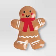 a ginger shaped cookie with a red scarf around it's neck and eyes, on a white background