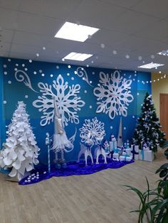 an office decorated for christmas with snowflakes and trees