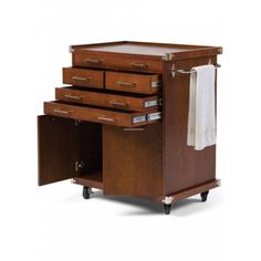 a wooden cabinet with three drawers and two towels on it's casteor wheels