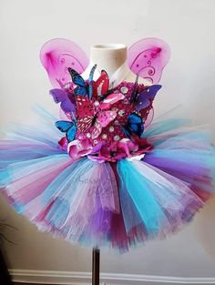 This tutu dress is handmade 100% . It features a stretchy bodice, Rhinestones accents. Perfect for Valentine's Day, pageants, birthdays, holidays, dress up, etc. Fitted Fairy Kei Dress For Party, Multicolor Tulle Tutu Dress For Costume Party, Purple Tulle Fairy Dress For Party, Fitted Tulle Fairy Dress For Pageant, Whimsical Pink Tutu Dress For Costume, Fairytale Tulle Fairy Dress For Pageant, Fairytale Tulle Fairy Dress For Pageants, Whimsical Tulle Skirt Tutu Dress For Dress-up, Fairycore Tulle Tutu Dress For Parties