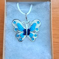 Handmade Blue Crystal Butterfly Necklace Made With Enamel Butterfly On White Cord Chain. Pendant Butterfly Measures 28mm In Shining Plated Silver. Pendant Features Enamel Blue Shades With Blue Crystal Stones. The Butterfly Is A Symbol Of Endurance And Hope. Chain Is Adjustable With Claw Clasp Closure. Box Display Only. Pouch Included Free. New And Unused Item. Contact Me With Any Offers. Nickel-free Blue Necklace - Perfect Gift, Blue Nickel-free Necklace As Gift, Blue Nickel-free Necklaces As Gift, Nickel-free Blue Necklace Perfect For Gifts, Nickel Free Blue Necklace For Gift, Blue Butterfly Sterling Silver Jewelry, Blue Jewelry With Butterfly Charm For Jewelry Making, Blue Butterfly Necklace For Gifts, Blue Butterfly Necklace For Gift