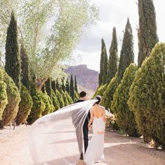 the bride and groom are walking down the road