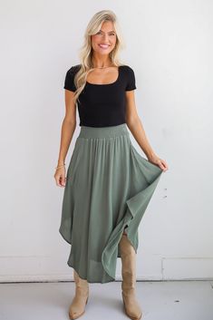 If you have iconic intentions, then the Sensational Purpose Olive Midi Skirt is the perfect look to achieve them! Designed with a flattering high-waisted fit, this skirt gracefully drapes to a midi length, creating a beautiful, flowing silhouette that moves with you. The rich olive hue adds a sophisticated, earthy tone that pairs beautifully with both neutrals and vibrant colors, making it a versatile addition to any closet. Crafted from lightweight, breathable fabric, this skirt offers a soft, Spring Tiered Skirt With Wide Waistband, High Waist Flowy Skirt With Wide Waistband, Chic Stretch Tiered Skirt, Relaxed Asymmetrical Rayon Maxi Skirt, Chic Lightweight Skirt With Wide Waistband, Chic Flowy Skirt With Wide Waistband, Chic Spring Skirt With Wide Waistband, Asymmetrical Relaxed Maxi Skirt With Elastic Waistband, Asymmetrical Maxi Skirt With Elastic Waistband