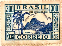 a stamp with an image of mountains and palm trees