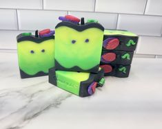 three soap bars with green and purple designs on them