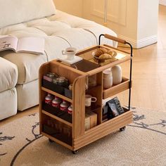 a living room filled with furniture and a coffee table on top of a wooden cart